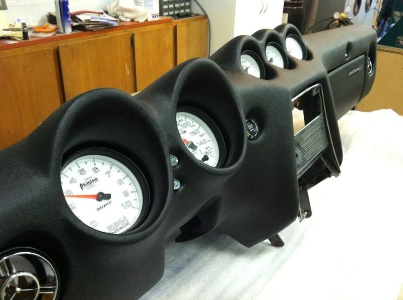 A dashboard with a tachometer that says rpm on it