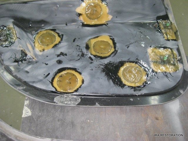 A piece of metal with a lot of holes in it