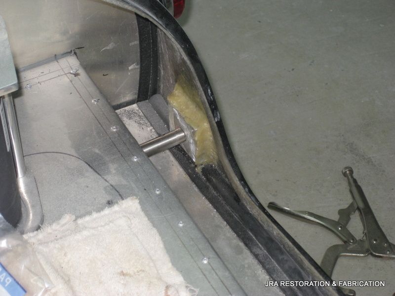 A piece of metal is being worked on with a pair of pliers