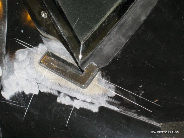 A close up of a piece of metal that says jba restoration