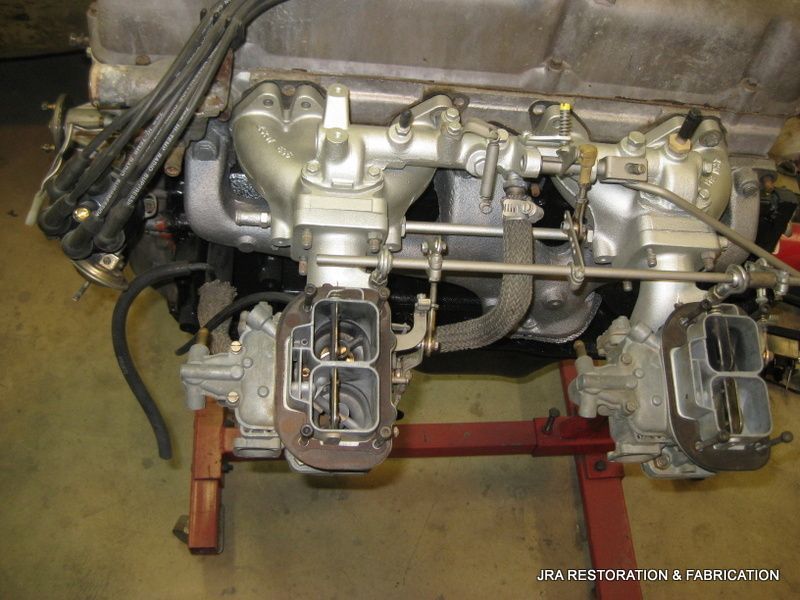 A close up of a carburetor on a car engine