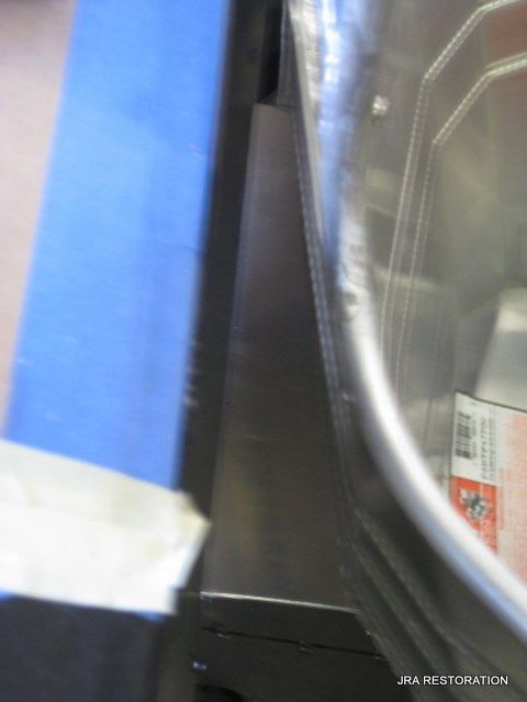 A stainless steel container with a label that says jra restoration