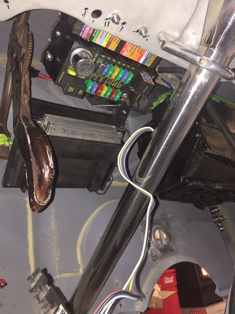 A bunch of wires are hanging from a metal pole