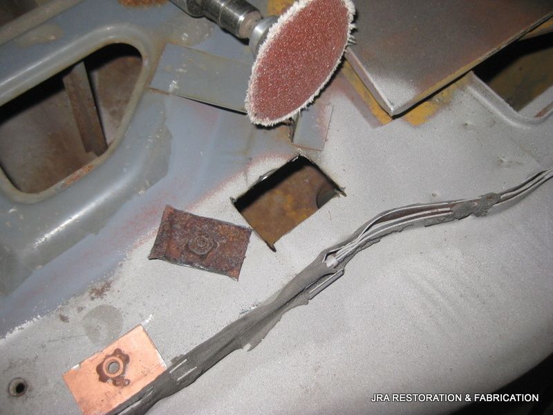 A piece of metal is being sanded with a sanding disc