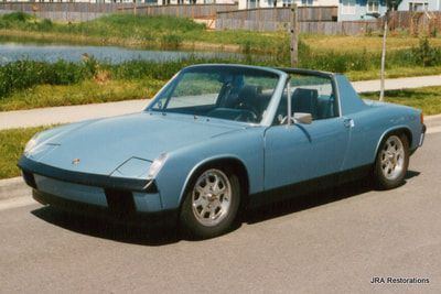 A blue car is parked on the side of the road