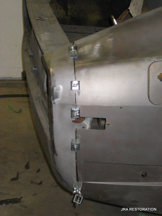 A close up of a car with the words jra restoration on the bottom