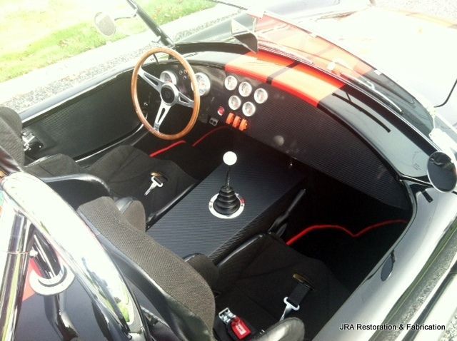 The inside of a car with a steering wheel and a shifter