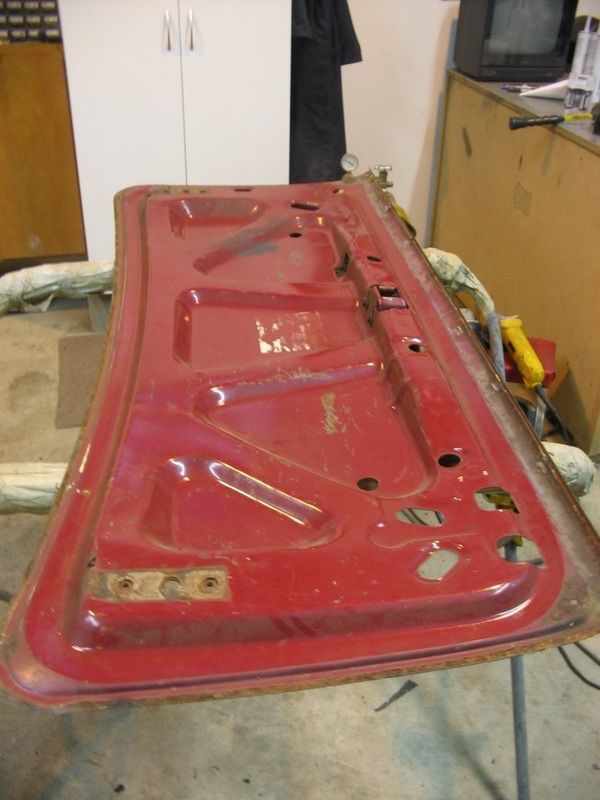 A red piece of metal is sitting on a table