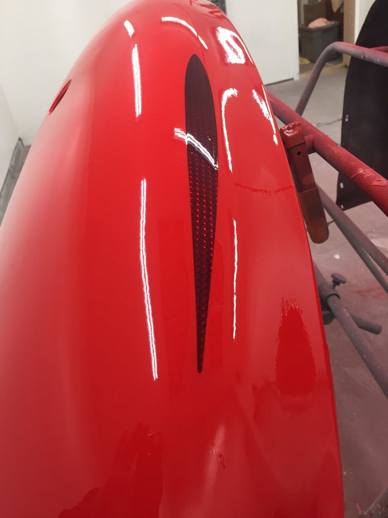 A close up of a red object with the letter g on it