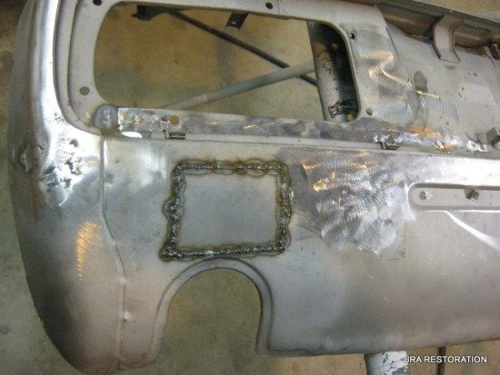 A silver car bumper with a hole in it