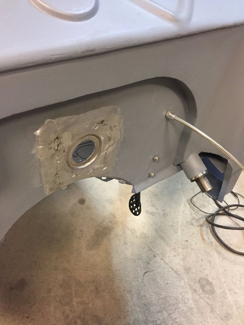A sink with a hole in it and a hair dryer next to it.