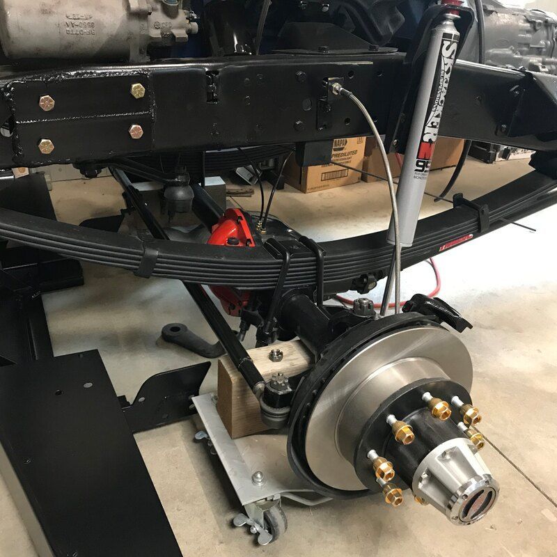 A close up of a brake and shock on a vehicle