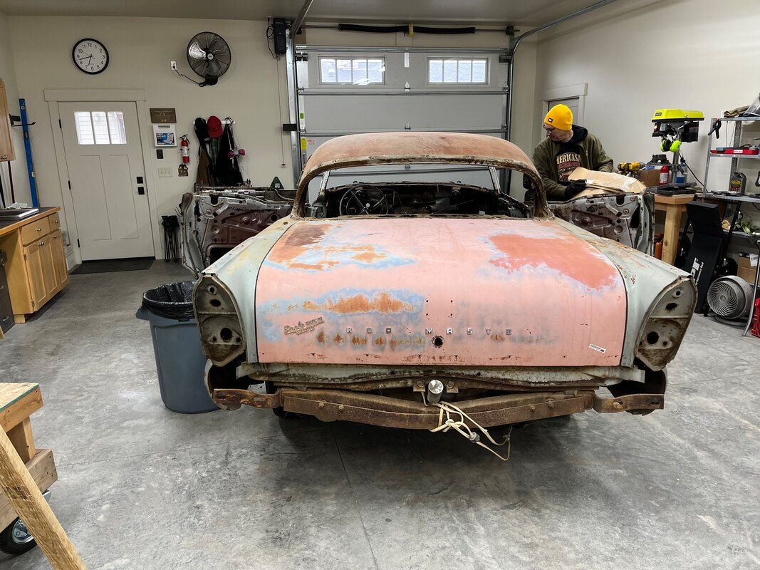 An old rusty 1958 Buick Roadmaster  is sitting in a garage.