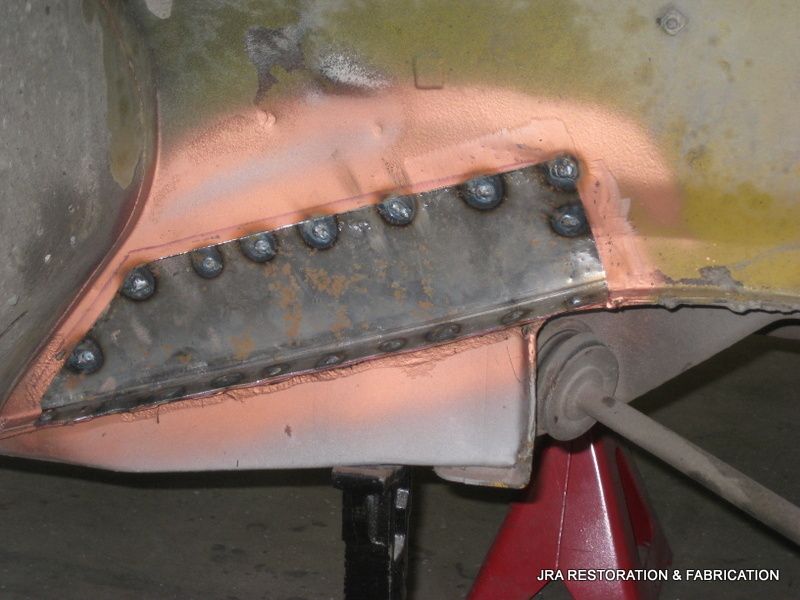 A piece of metal is sitting on a red jack stand ..