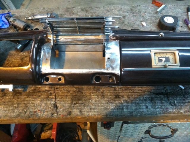 A black dashboard is sitting on a wooden table