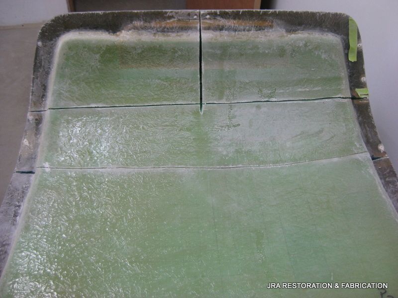 A piece of green plastic is sitting on top of a table.