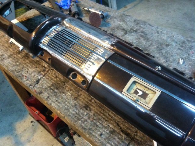 A black car dashboard is sitting on a wooden table