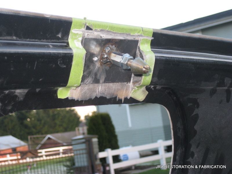 A piece of green tape is taped to a piece of metal