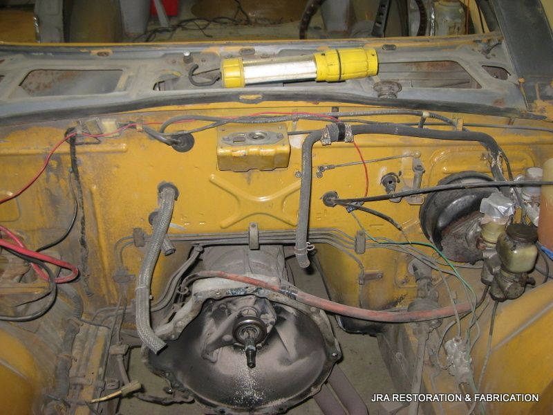 The inside of a yellow car with a yellow light on the hood