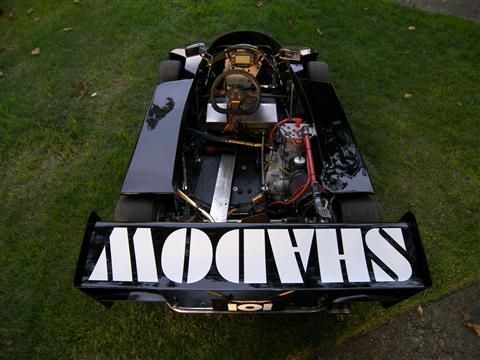 A shadow go kart is parked in the grass