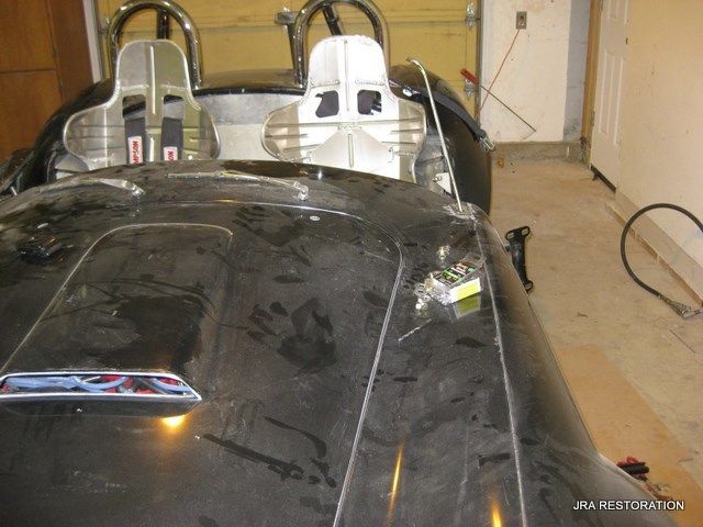 A black sports car is sitting in a garage