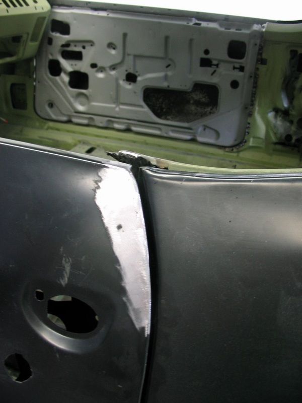 A close up of a car door with a hole in it