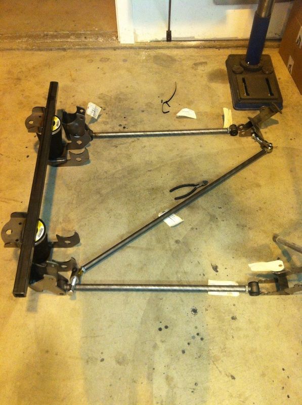 A piece of metal is sitting on a concrete floor.