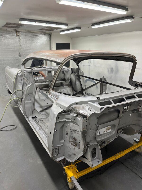 A car is being built in a garage.