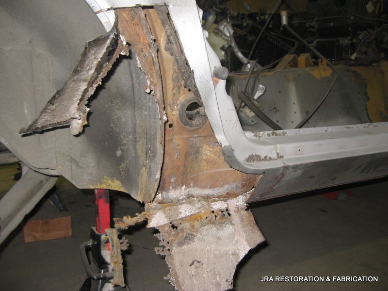 A piece of rusty metal is sitting on top of a wooden table.
