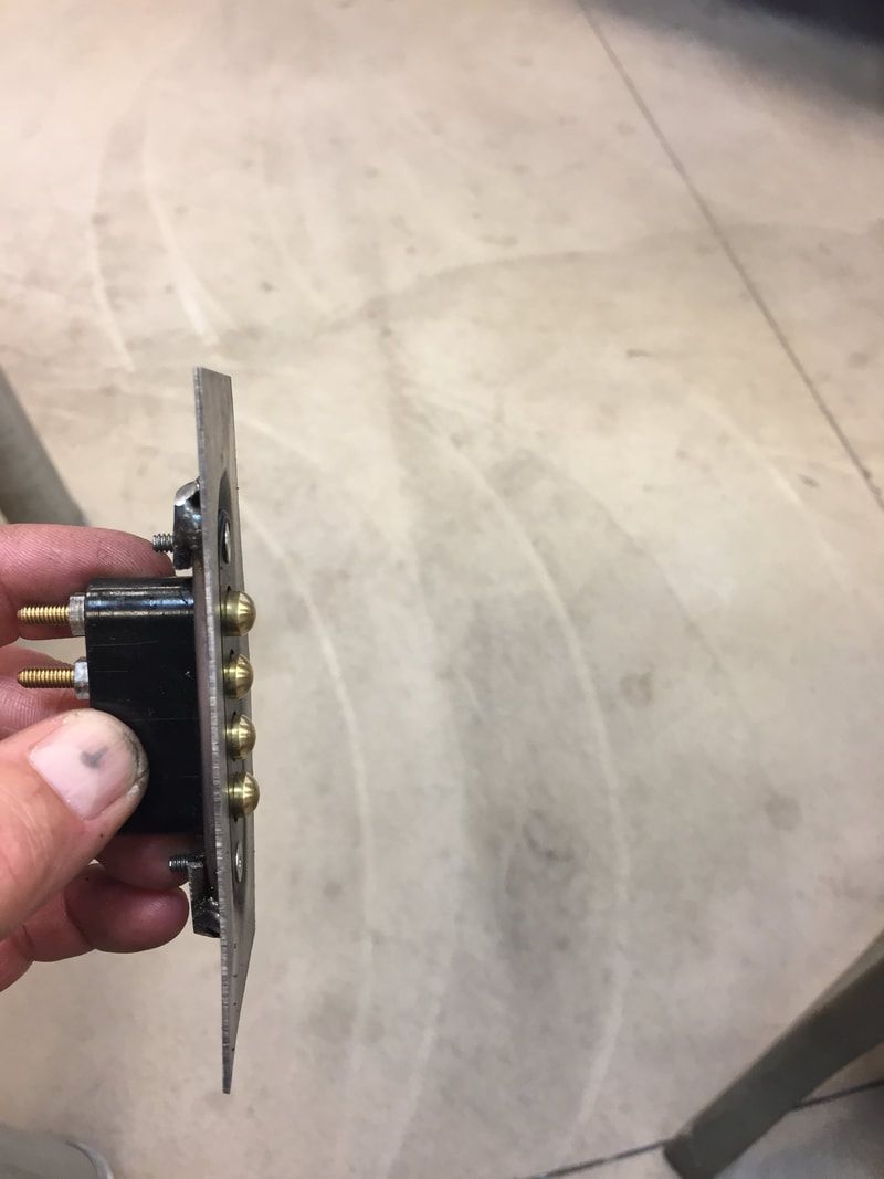 A person is holding a piece of metal in their hand.