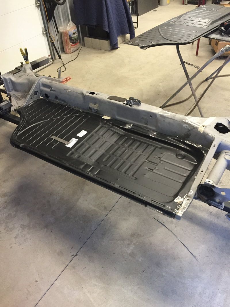 A piece of metal is sitting on the ground in a garage.