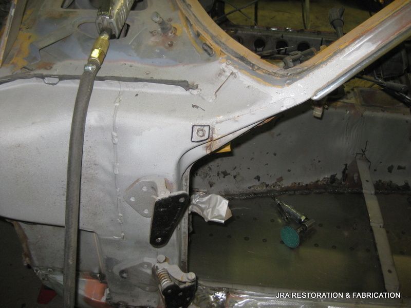 A car is being restored by a company called restoration & fabrication