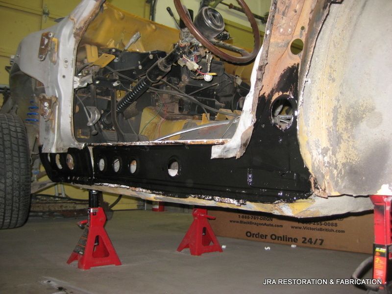 A car is being worked on in a garage with a box in the background that says order online 24 7