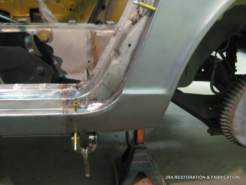 A car is sitting on a jack while being worked on