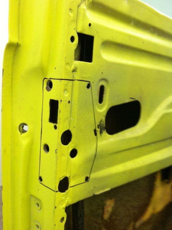 A close up of a yellow door with holes in it