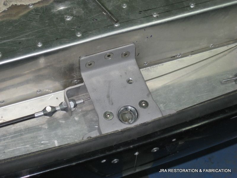 A close up of a metal item with the words jra restoration & fabrication on the bottom