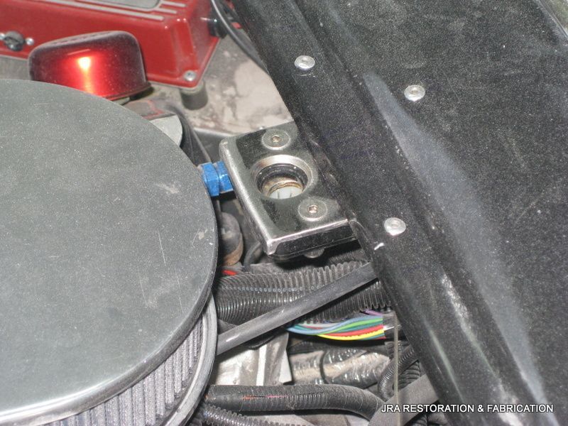 A close up of a car engine with a filter on it