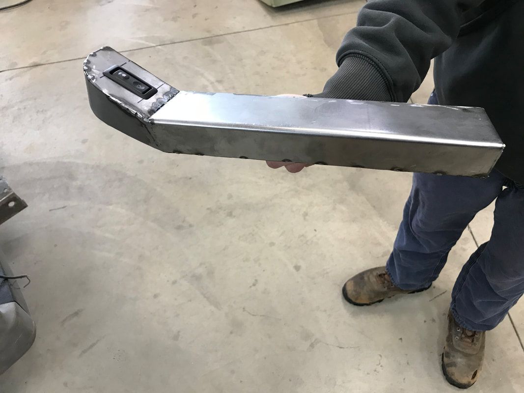 A person is holding a piece of metal in their hands