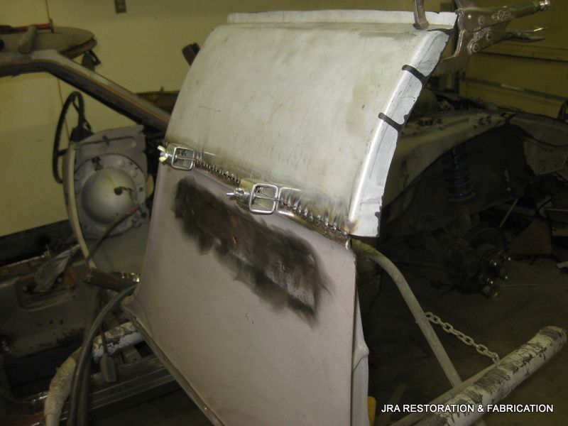 A piece of metal that says jra restoration & fabrication on it