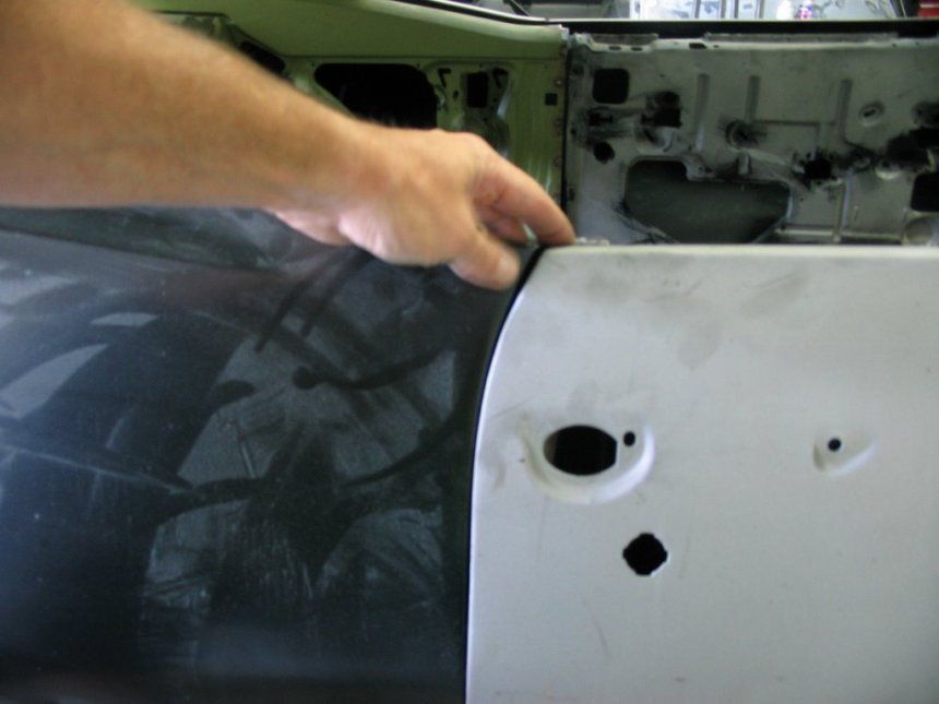 A person is working on the side of a car