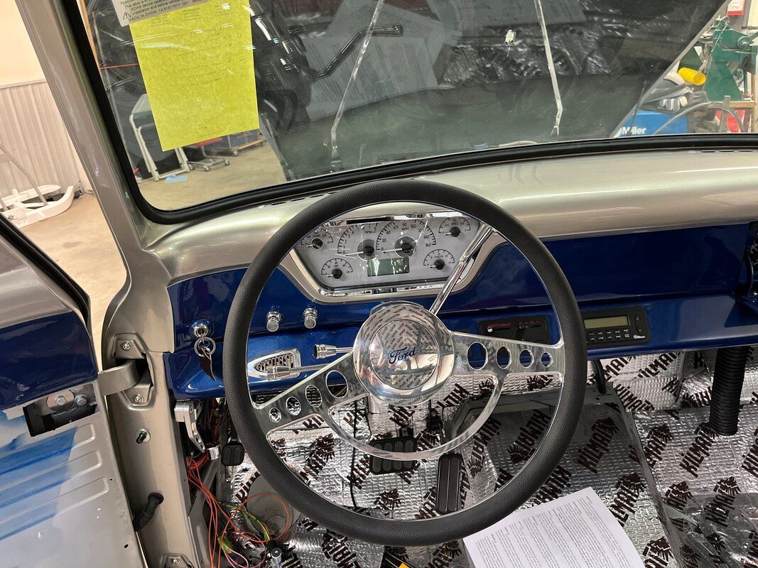 A close up of a steering wheel in a car.