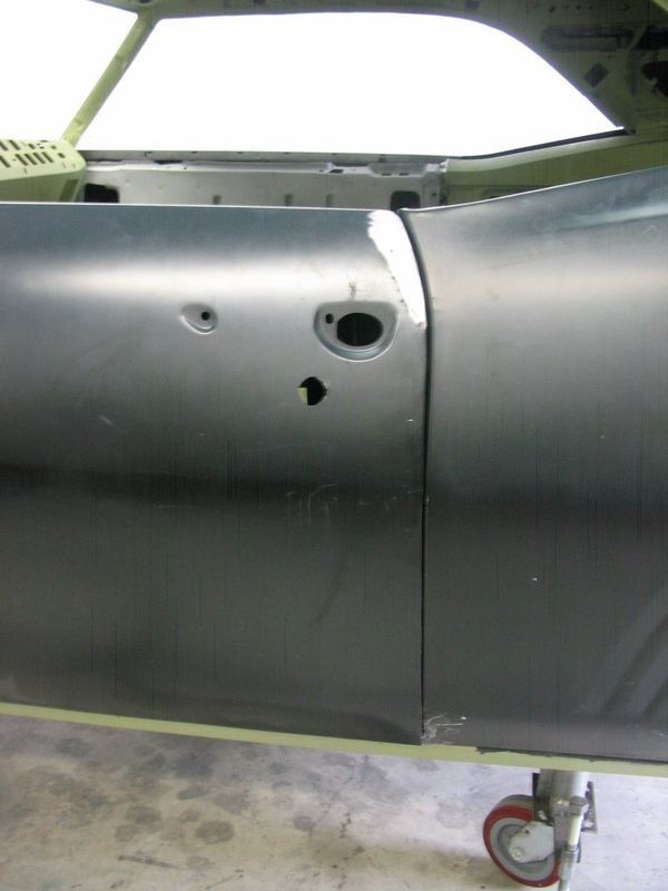 A close up of a car door with a hole in it