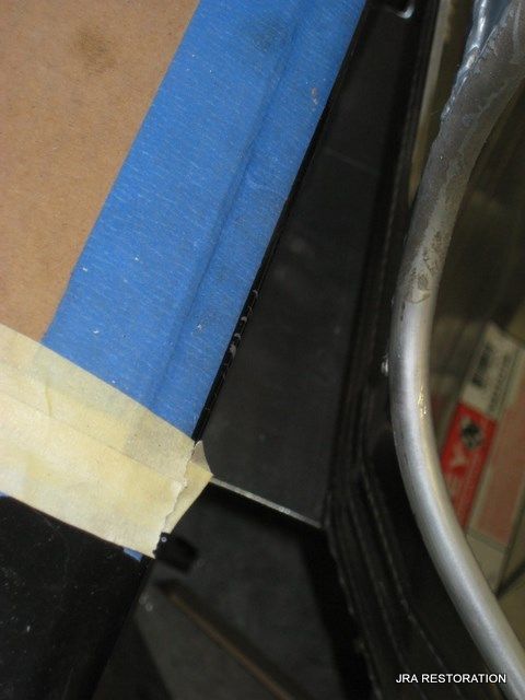 A piece of blue tape is on a piece of wood