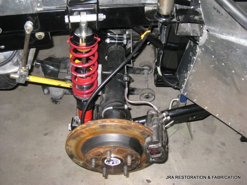 A close up of the underside of a car with the words jsa restoration & fadi cat on the bottom