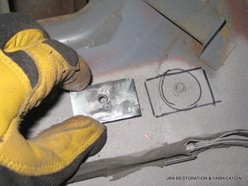 A person wearing yellow gloves is working on a piece of metal