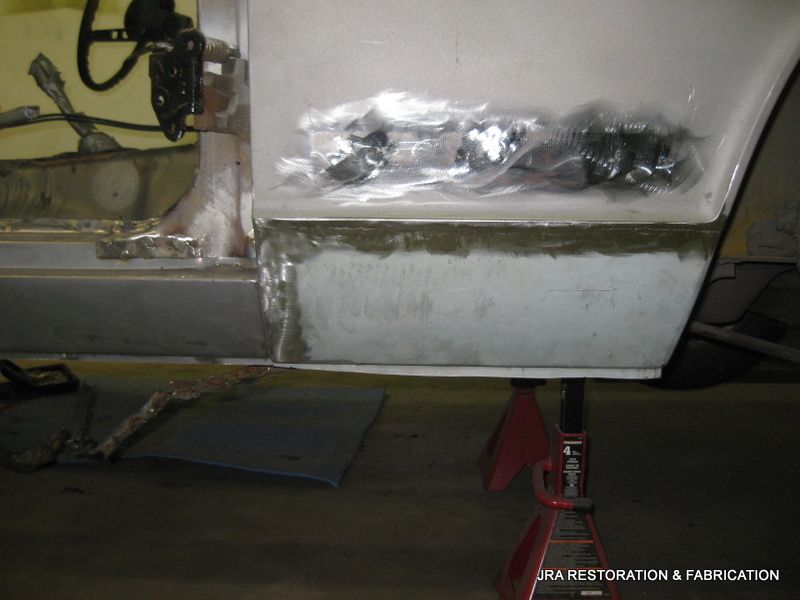 A piece of metal is sitting on a red jack stand ..