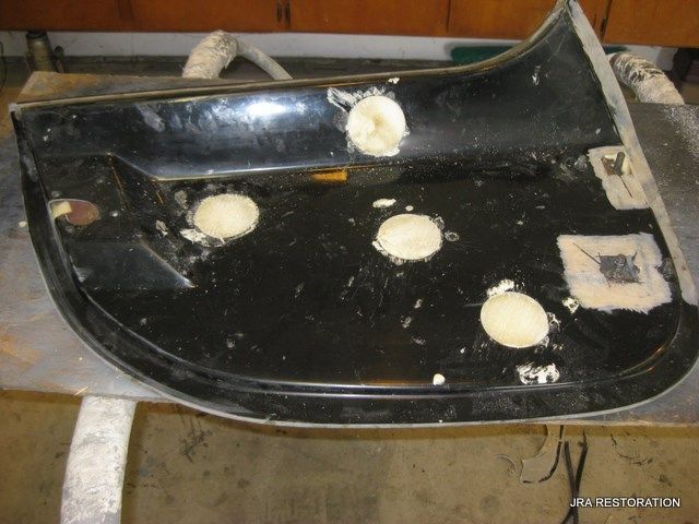 A piece of black plastic with holes in it is sitting on a table ..