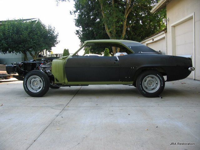 A black car is parked in front of a garage