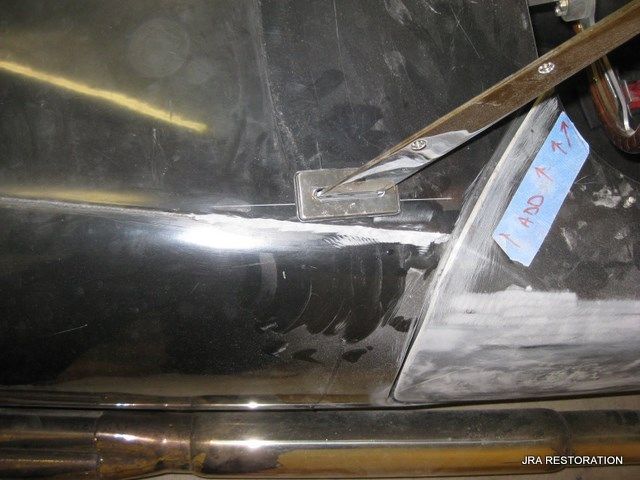 A piece of metal with a blue tag on it that says jra restoration