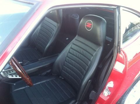 A red car with black seats and the letter z on the back